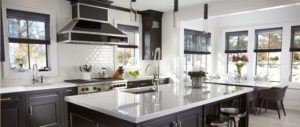 Breakfast nook and room with a modern black kitchen by Kitchen Designs by Ken Kelly