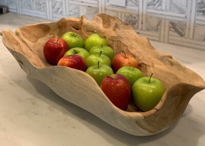 art in the kitchen - wooden dough bowl filled with apples