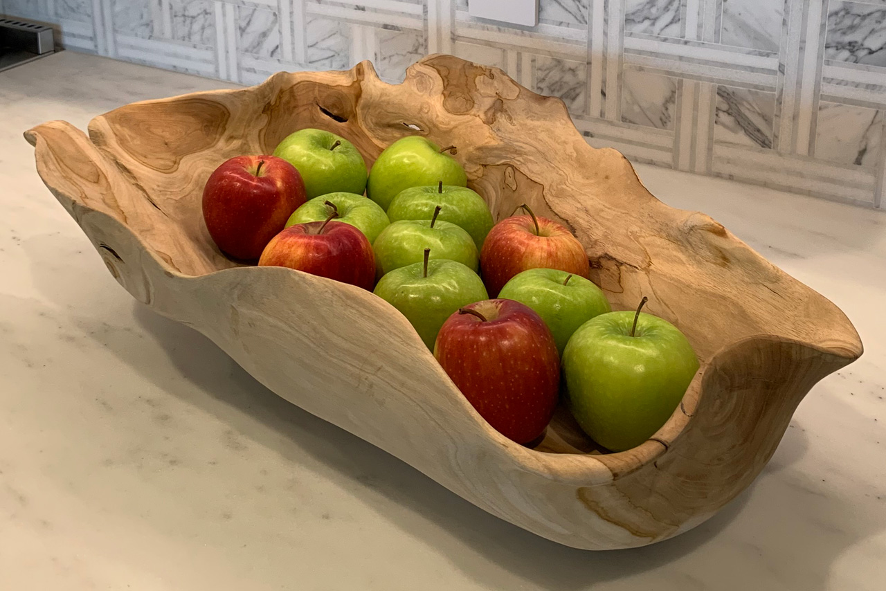 art in the kitchen - wooden dough bowl filled with apples