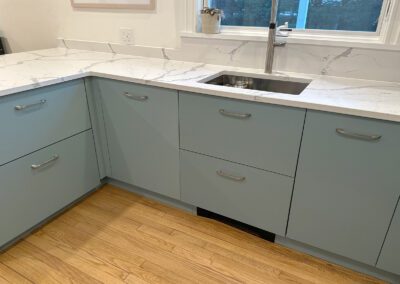 full white slab countertop - stainless steel sink