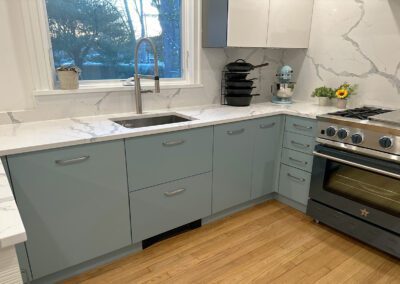 full white slab countertop - stainless steel sink