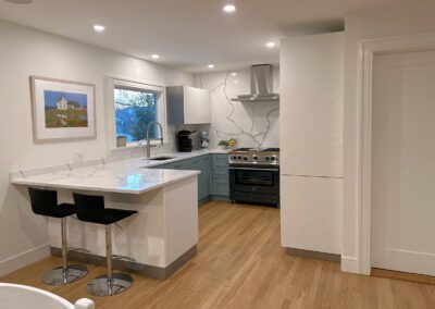 full white slab countertop - teal kitchen cabinet - Full Kitchen View