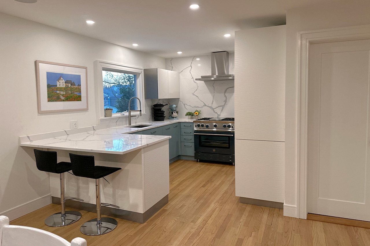 full white slab countertop - teal kitchen cabinet - Full Kitchen View