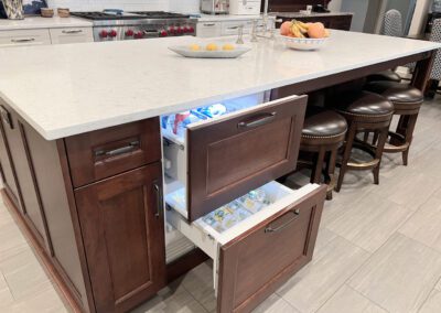 Kitchen Island Closeup, Island Electric Outlet, Sliver Kitchen Faucet, Integrated Freezer Drawer, Bar Stools